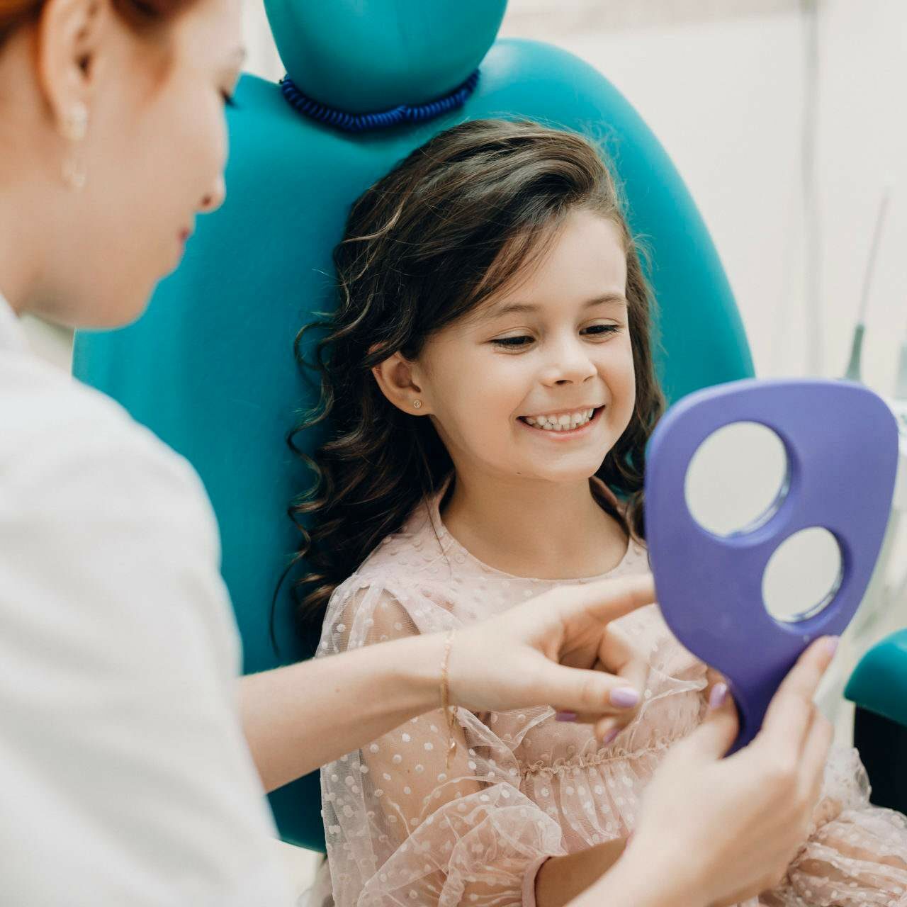 Close Up Portrait Lovely Little Girl Looking Mirror Dentist After Examination Smiling Little Kid Smiling Stomatology Examination Circle Kid's Denstistry - Take care of your kid's smile